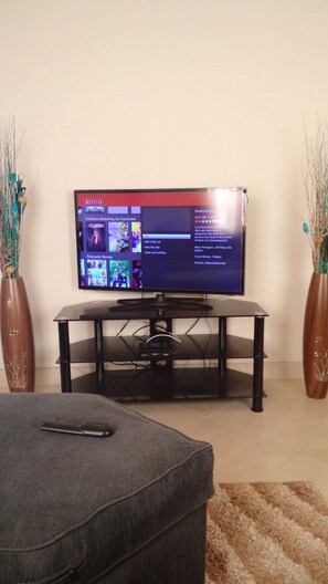 Relax in this cozy living space with a flat-screen TV and comfortable seating.