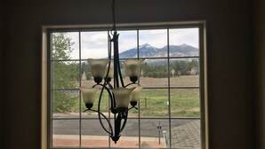 A chandelier in a room with a large window. - Peak View Retreat, 3 Bedroom Sleeps 6 (Flagstaff)