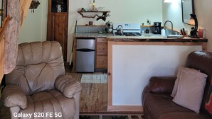 A rustic interior with a loft bedroom, a kitchen, and a seating area. - A remote cabin surrounded by Pine, Birch and Aspen trees, five miles to Deadwood (Deadwood)