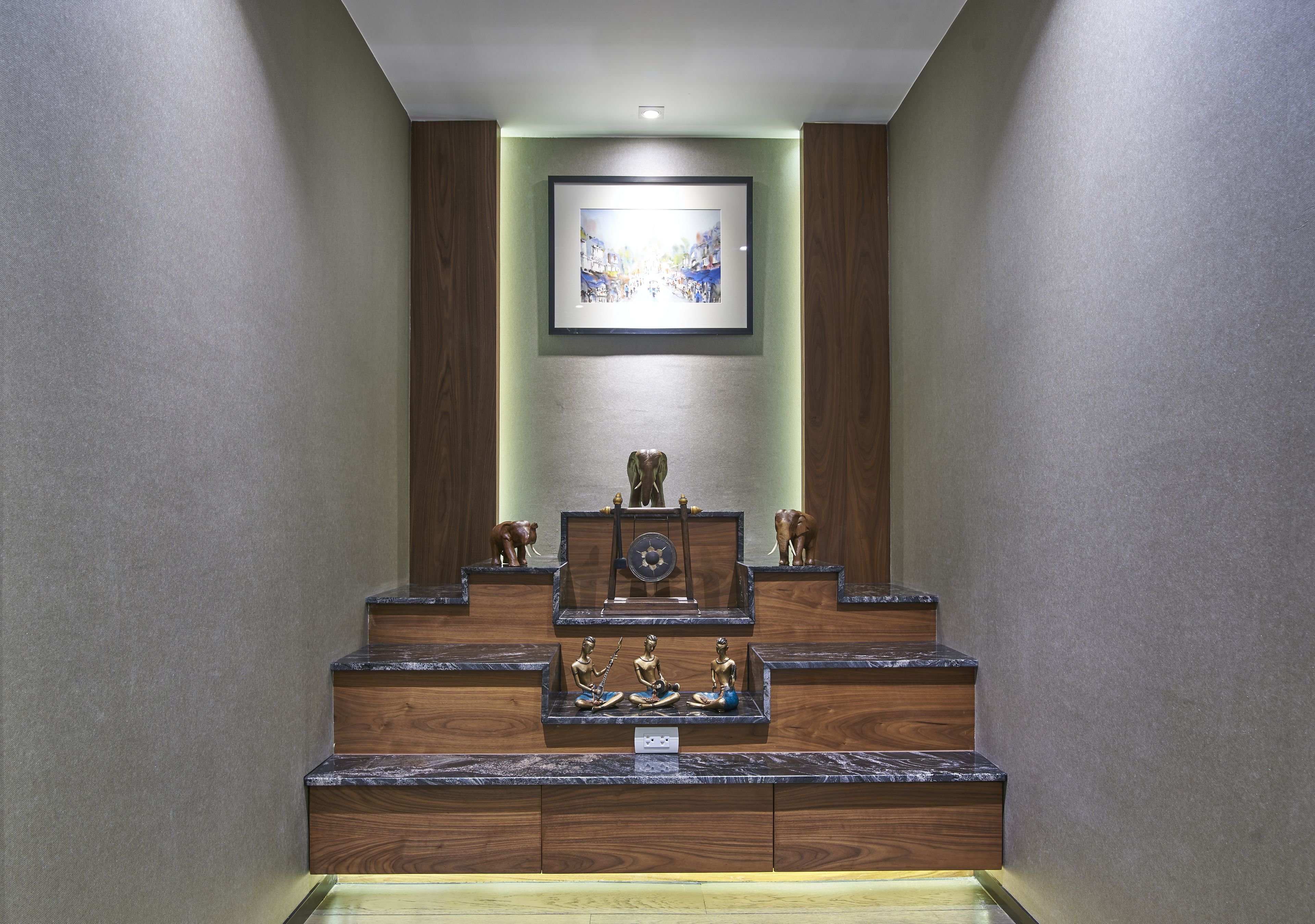 A staircase with wooden steps and a framed picture above.
