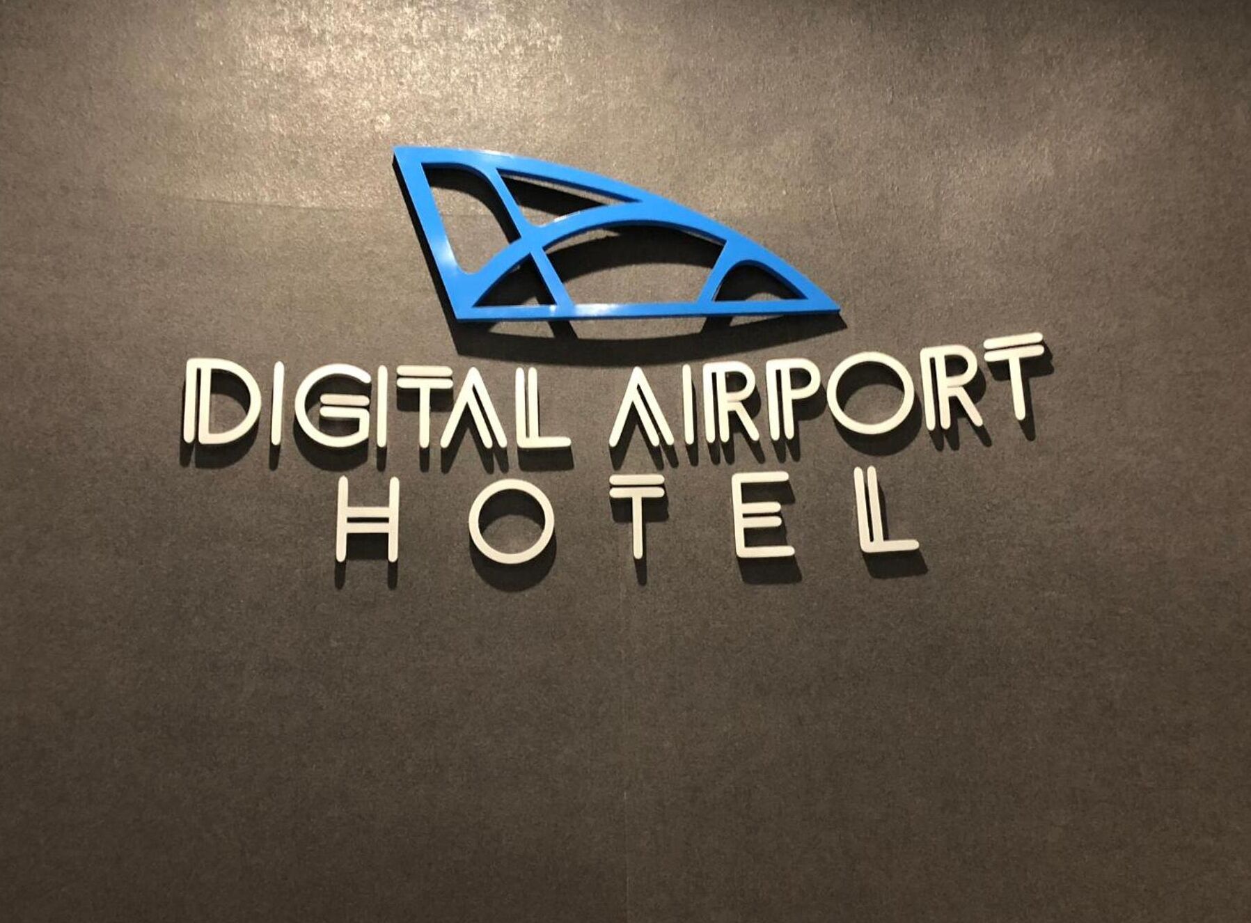 A sign for the Digital Airport Hotel with a stylized logo above the text.
