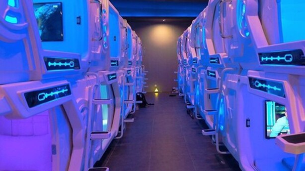 A row of massage chairs in a dimly lit room with a tiled floor. - PassGo Digital Airport Hotel Terminal 3 Soekarno Hatta (Tangerang)