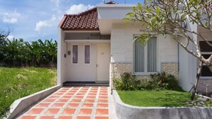 A modern two-story house with a tiled entrance, a small garden, and a visible number '85' on the door. - Bale Village B5 Villa with Private Pool (Kerobokan)