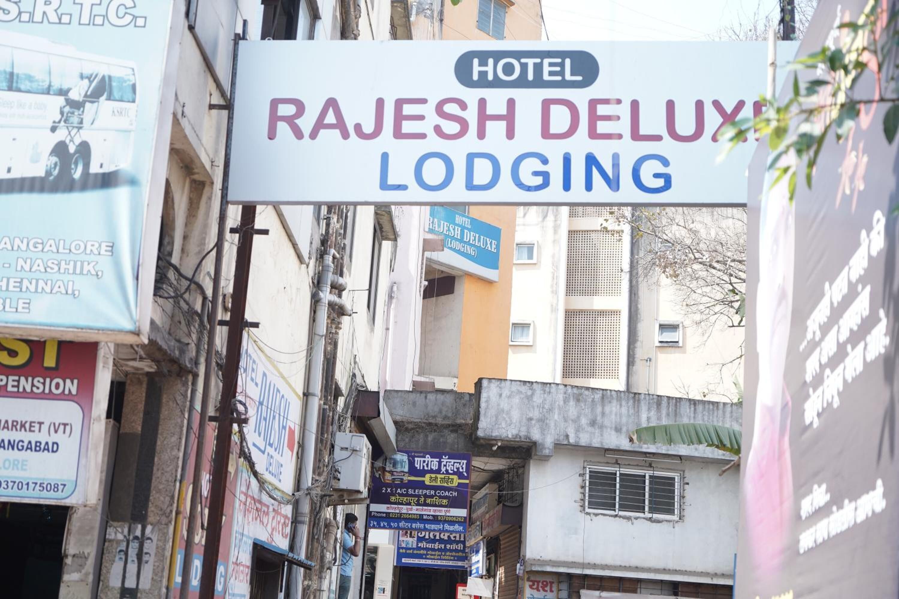 A sign for Rajesh Deluxe Lodging, a hotel.