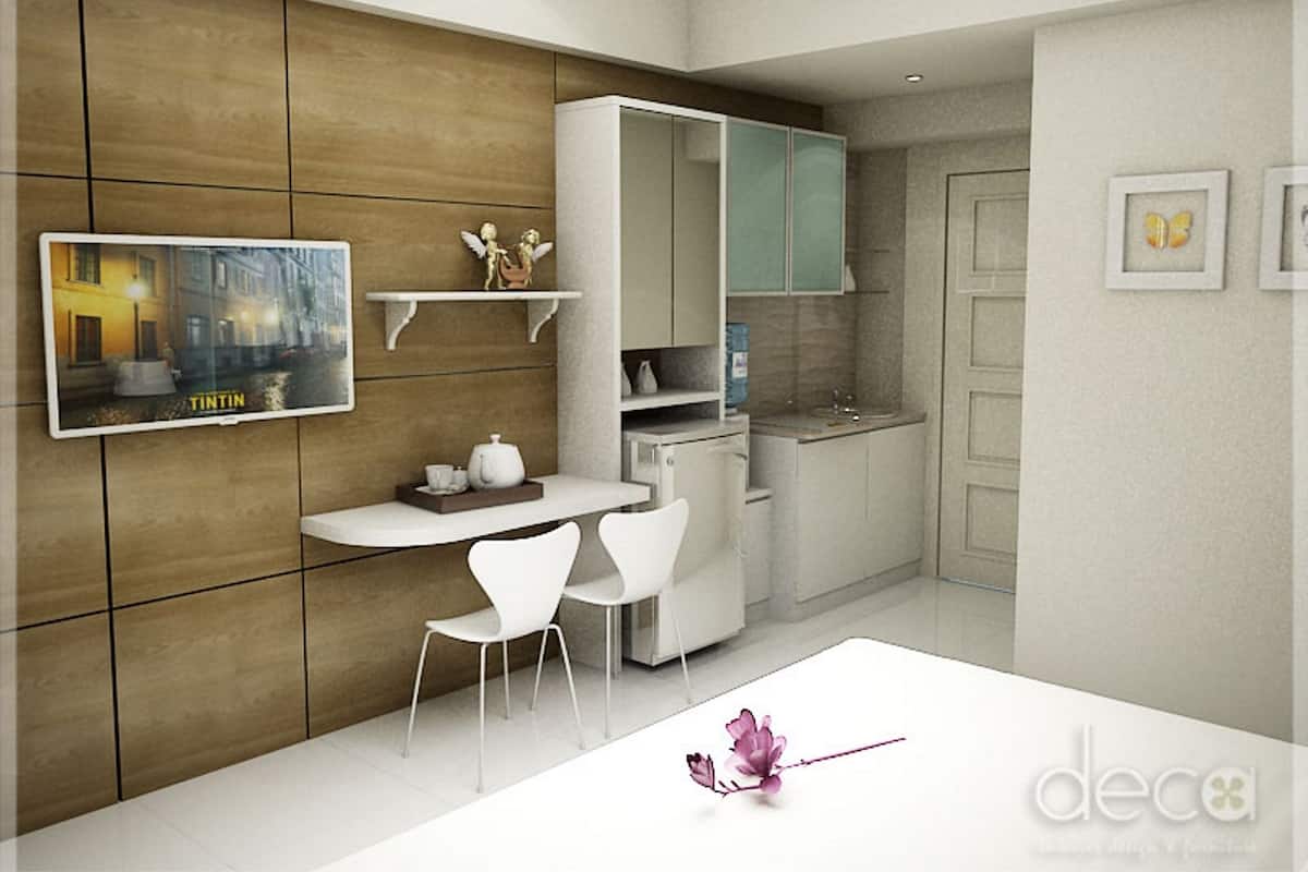 A modern kitchen with white cabinetry, a dining area with a white table and chairs, and a decorative item on the table.