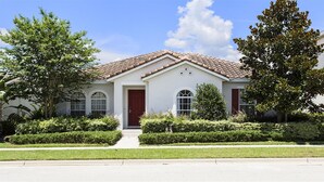 A single-story house with a red-tiled roof, a front door, and two windows. - Je62762 - Reunion Resort - 4 Bed 2 Baths Villa (Kissimmee)