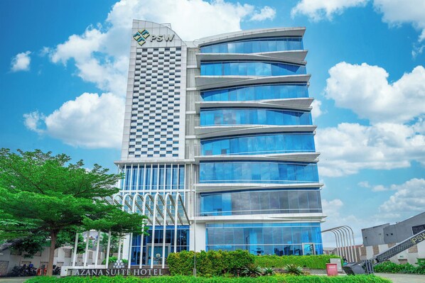 A modern hotel with a checkered facade and multiple blue-glass windows.
