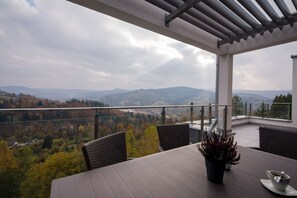 A balcony with a view of a mountainous landscape.