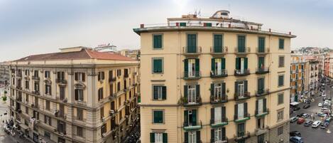 A multi-story building with a classic architectural style, featuring balconies and a central courtyard.