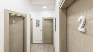 A hallway with doors numbered 2, 3, and 5. - Opera Home Principe Umberto (Naples)