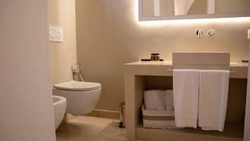 A modern bathroom with a toilet, sink, and towel rack.
