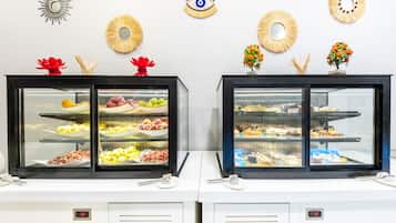 Two display cases with food items, a wall clock, and decorative wall art.