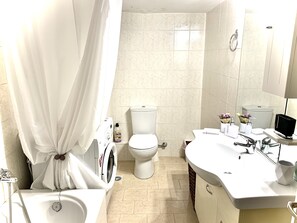 Combined shower/tub, hair dryer, towels, soap