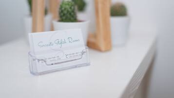 A business card for 'Sorrento Stylish Rooms' with contact information.