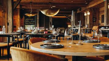 Ein Restaurant mit Holzeinrichtung, runden Tischen und Stühlen.