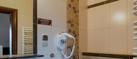 A bathroom with a sink, toilet, and a towel rack.