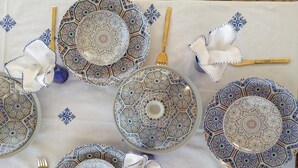 A table set with patterned plates, gold cutlery, and white napkins. - Dar La Bague De Kenza (Fes)