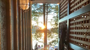 A wooden pathway leading to a deck with a view of trees and a sunset. - Lakeside life at its best! (Enfield)