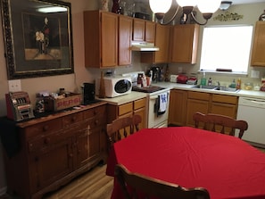 Enjoy meals in this kitchen with a dining table, microwave, and kettle, and take in the view from the window.