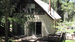 A two-story house with a sloped roof, large windows, and a chimney. - Year-Round Lake Tahoe Getaway -- Comfortable and Spacious! (South Lake Tahoe)