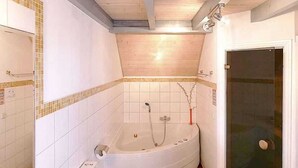 A bathroom with a bathtub, toilet, and sink.