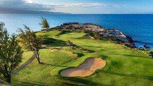 A golf course with a coastal view, a sandy bunker, and a clear sky. - Dramatic Ocean Views - Fantastic Location - REDUCED RATES! (Kapalua)