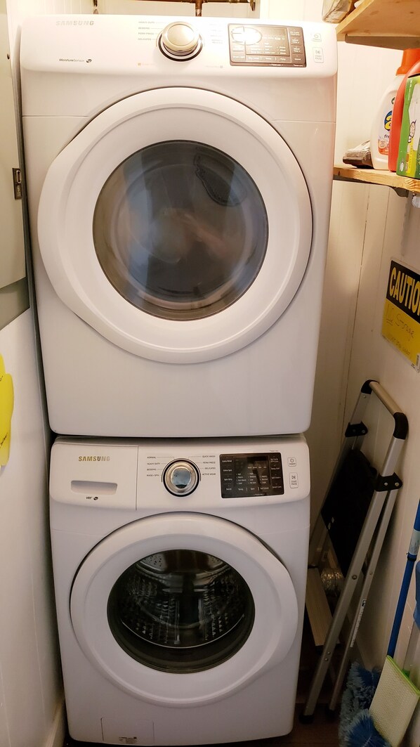 A stacked washer and dryer unit with a moisture sensor and control panel.