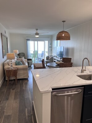 Enjoy a comfortable stay in this apartment with a spacious living area, dining table, and kitchen with modern appliances.
