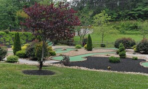 Golfers can enjoy a well-maintained course with winding paths and green areas.