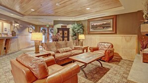A lobby with leather sofas, a coffee table, and a reception desk. - River Run Condo, 200 yards to gondola, Slope Views, Heated Garage, Free WiFi (Keystone)
