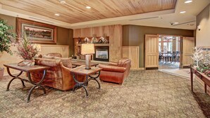 A spacious lobby with a wooden ceiling, a fireplace, leather sofas, and a patterned carpet. - River Run Condo, 200 yards to gondola, Slope Views, Heated Garage, Free WiFi (Keystone)