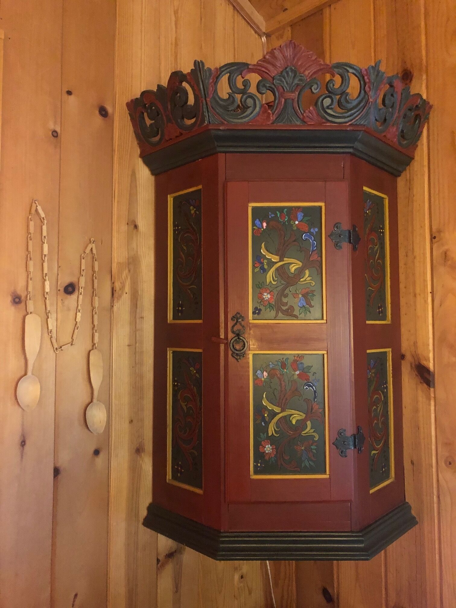 A wooden cabinet with ornate carvings and floral designs.