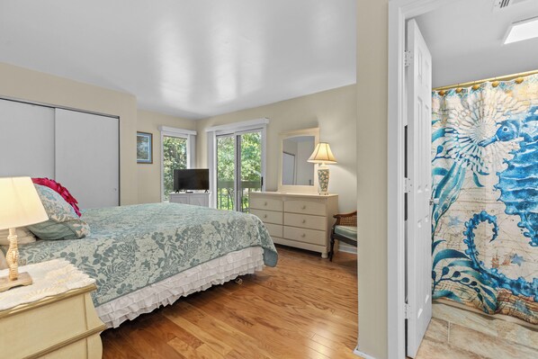 A bedroom with a bed, dresser, and a large window. - A+Coastal Escape: Beach, Golf, Tennis Club Access Available (Seabrook Island)
