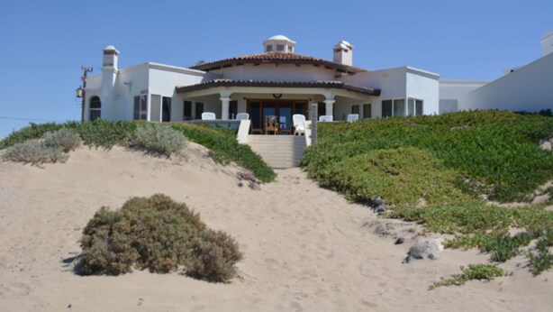 A coastal house with a curved roof, a central entrance, and a staircase leading up to the front door. - Beachfront House in Las Concha's.   (Puerto Penasco)