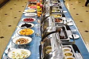 A buffet table with various food items and containers. - Chen Xiang Guest Hotel (Xinyu)