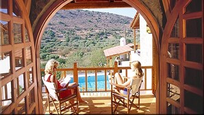 A balcony with a view of a mountainous landscape.