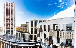 A modern building with multiple balconies and a rooftop garden. - Best Western Plus Royal Suites (Leipzig)