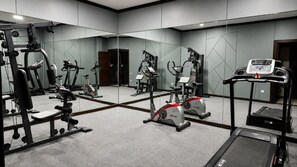 A gym with various exercise equipment including treadmills, stationary bikes, and weight machines. - Grand Capital Hotel (Tashkent)