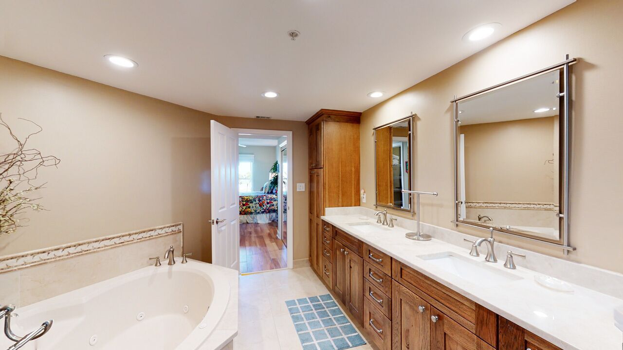 A modern bathroom with a double sink, a large mirror, and wooden cabinetry.