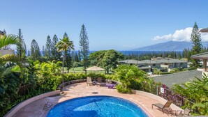 A pool area with lounge chairs, a small umbrella, and a view of a mountain range. - Great Deal $175/n (8/9-11/20) Ocean View AC-Kapalua Golf Villa 19T4-Sullivan (Lahaina)