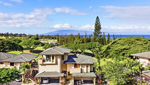 A residential area with houses, a mountain in the background, and a clear sky. - Great Deal $175/n (8/9-11/20) Ocean View AC-Kapalua Golf Villa 19T4-Sullivan (Lahaina)
