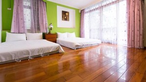 A room with two beds, a nightstand, a lamp, and a framed picture on the wall. - Dog House (Taitung)