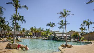 Relax by the pool surrounded by lush palm trees and beautifully maintained gardens.
