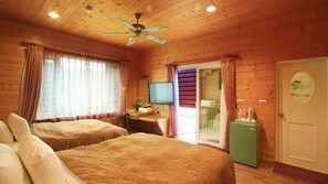 A wooden cabin room with two beds, a television, and a small refrigerator. - Hooja hotel (Ren'ai)