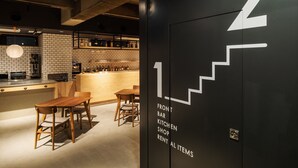 A modern interior with a bar, kitchen, and shop area. - 9 C Hotel Asahikawa (Asahikawa)