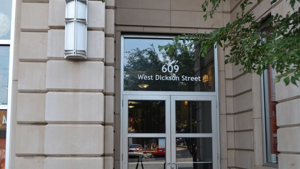A building entrance with a sign reading "609 West Dickson Street". - 6th Floor Condo in The Dickson with View of Old Main (Fayetteville)