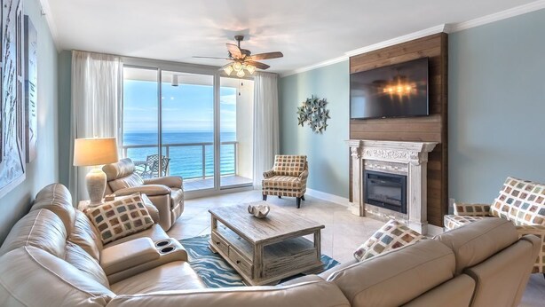 A spacious living room with a sofa set, a fireplace, and a television. - Beautifully Condo BOOK TODAY (Navarre)