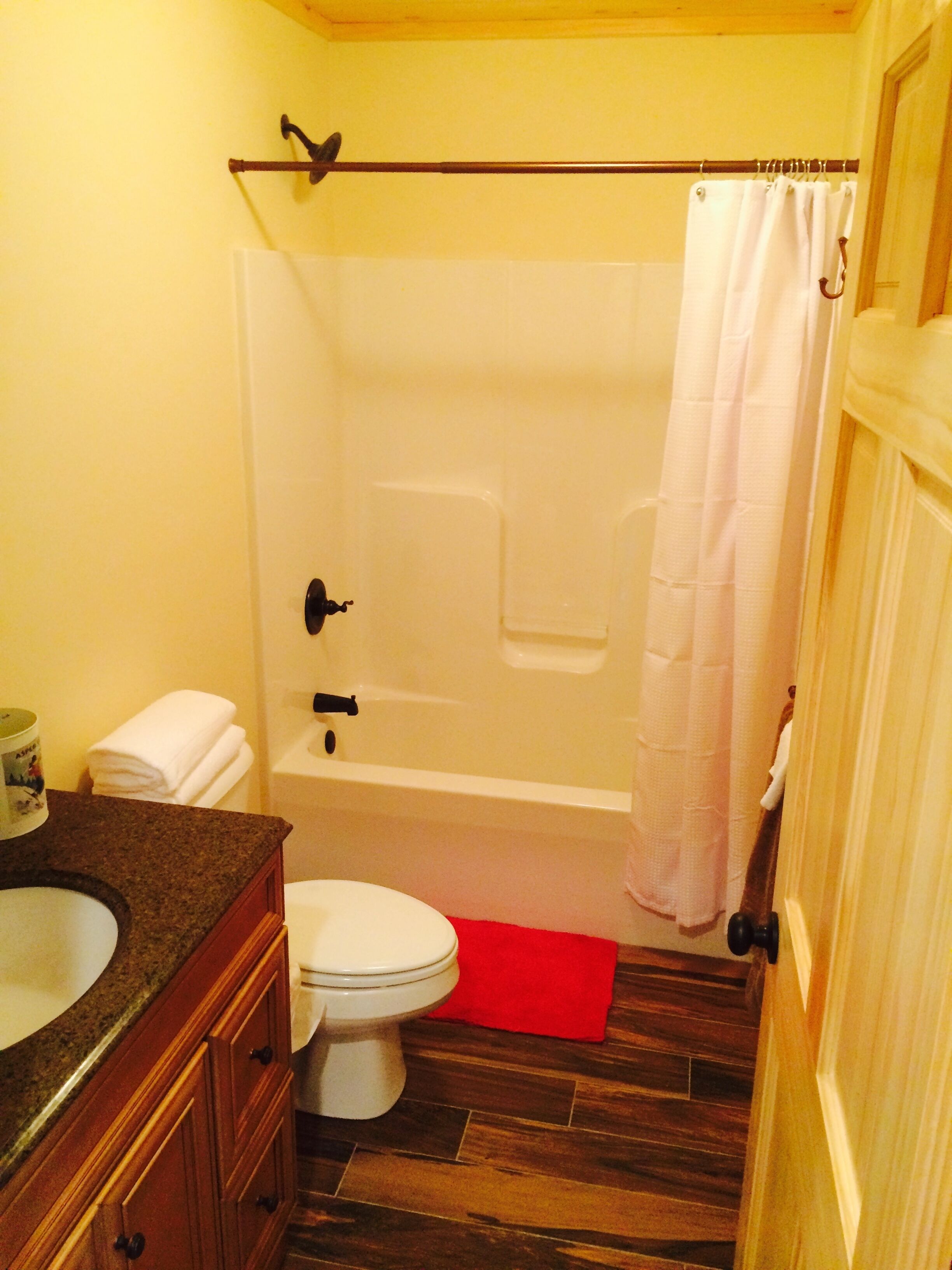 A bathroom with a toilet, sink, and bathtub.