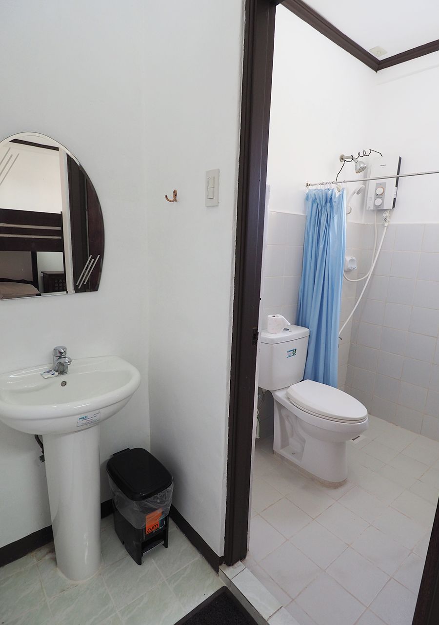 A bathroom with a sink, toilet, and shower.