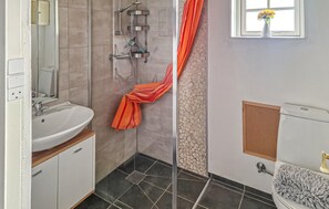 A bathroom with a shower, a sink, and a toilet. - 2 bedroom awesome home in østermarie (Østermarie)